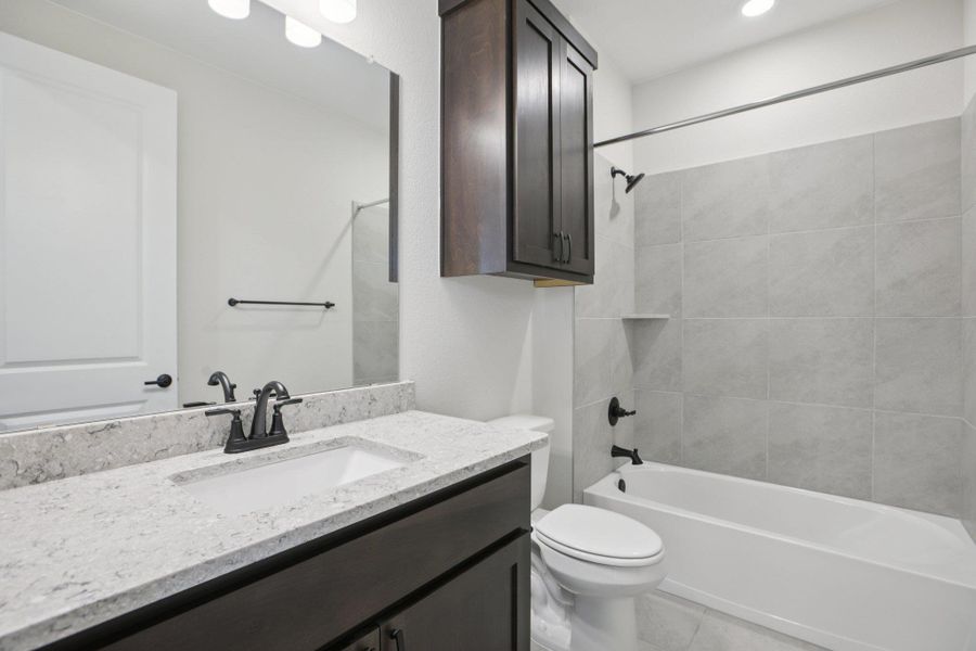 Full bath with tub / shower combination, vanity, light tile patterned flooring, and recessed lighting