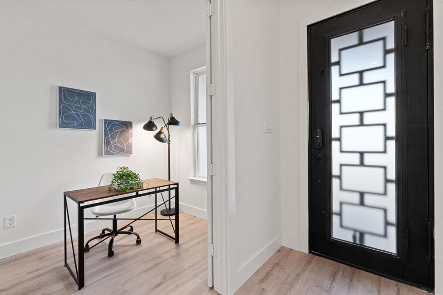 Foyer entrance featuring light hardwood / wood-style floors