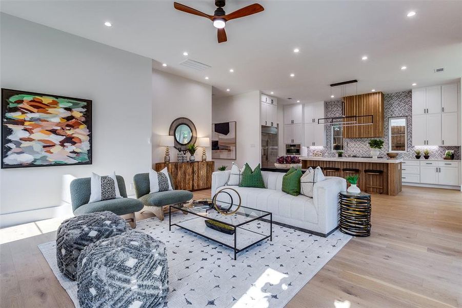 Living room featuring light hardwood / wood-style flooring and ceiling fan