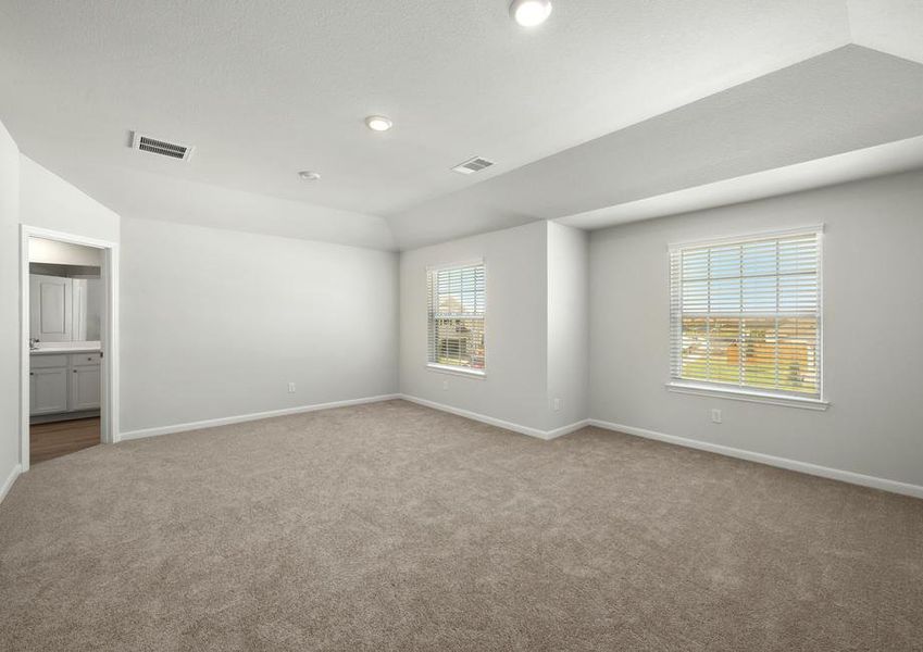 The master bedroom is spacious with large windows.