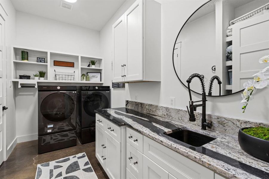 This exquisite utility room is thoughtfully designed with abundant storage, expansive countertops, and a sleek, built-in sink, combining functionality with elegance.