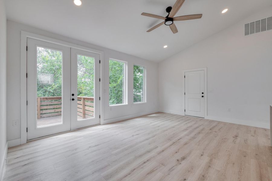A spacious room offers ample natural light and direct access to an outdoor deck, perfect for indoor-outdoor living. A spacious room offers ample natural light and direct access to an outdoor deck, perfect for indoor-outdoor living.