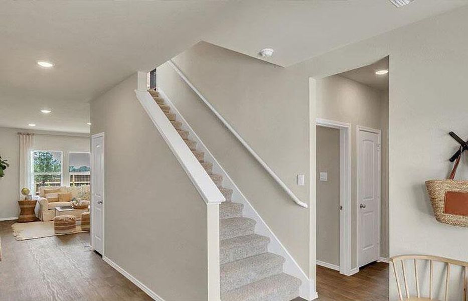 Stairway with wood finished floors, recessed lighting, and baseboards Stairway with wood finished floors, recessed lighting, and baseboards