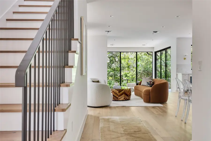 Modern staircase with wood treads and black metal balusters