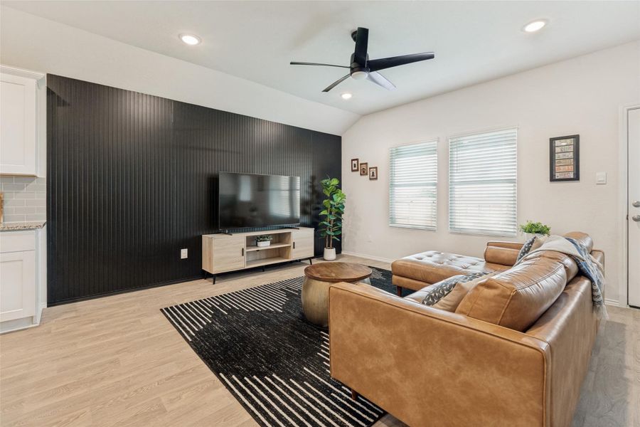 A striking accent wall provides a bold focal point in this inviting, open-concept living space.