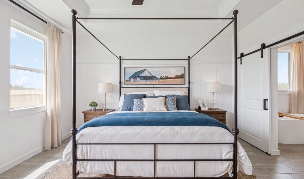 Primary suite with sliding barn door to private bath