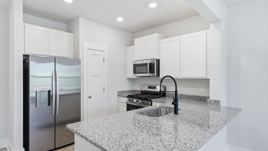 Vibrant kitchen layout with granite countertops, refined finishes, and open-concept flow near Lake Hartwell Vibrant kitchen layout with granite countertops, refined finishes, and open-concept flow near Lake Hartwell