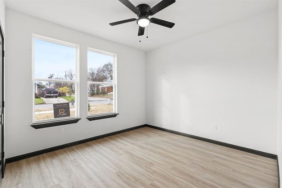 Spare room with ceiling fan and light hardwood / wood-style floors