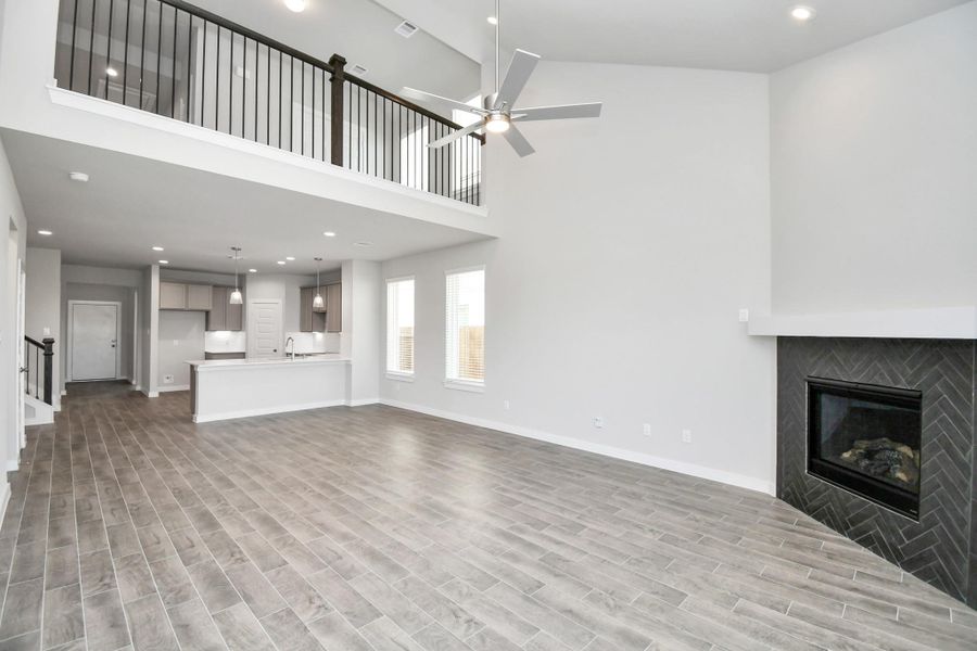 Gather the family and guests together in your lovely living room! Featuring soaring high ceilings, recessed lighting, ceiling fan, custom paint, gorgeous floors, and large windows that provide plenty of natural lighting throughout the day. Gather the family and guests together in your lovely living room! Featuring soaring high ceilings, recessed lighting, ceiling fan, custom paint, gorgeous floors, and large windows that provide plenty of natural lighting throughout the day.