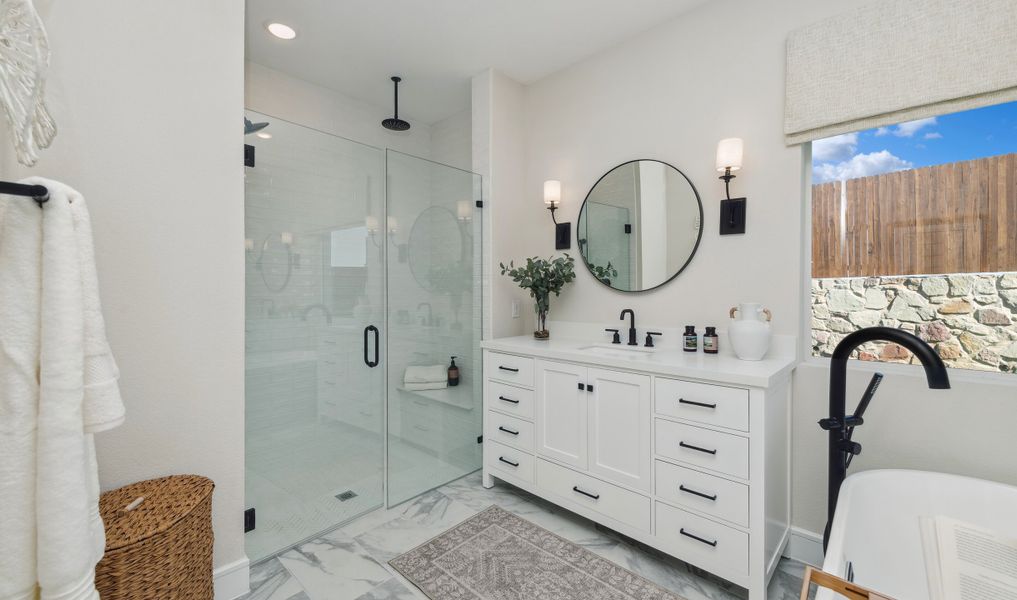 Primary bath w frameless shower door & dual vanities w matte black fixtures