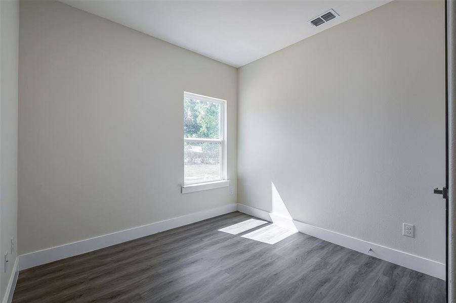 Empty room featuring hardwood / wood-style floors