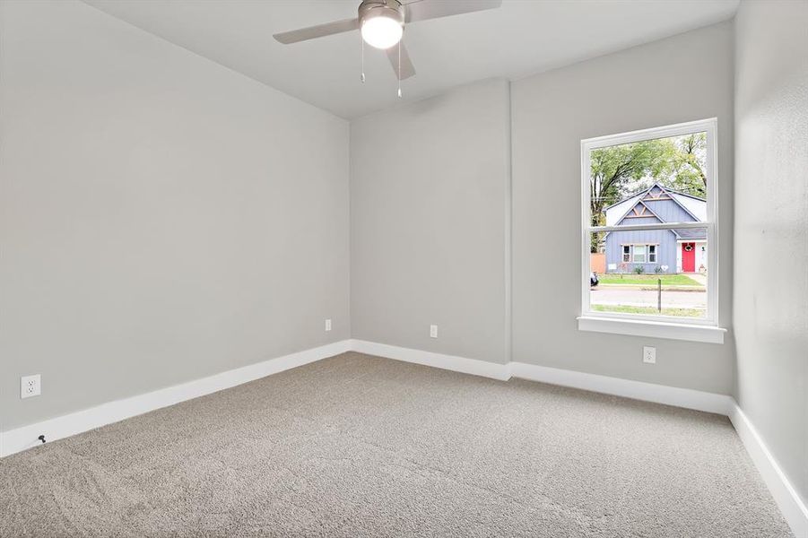 Unfurnished room featuring ceiling fan and carpet floors