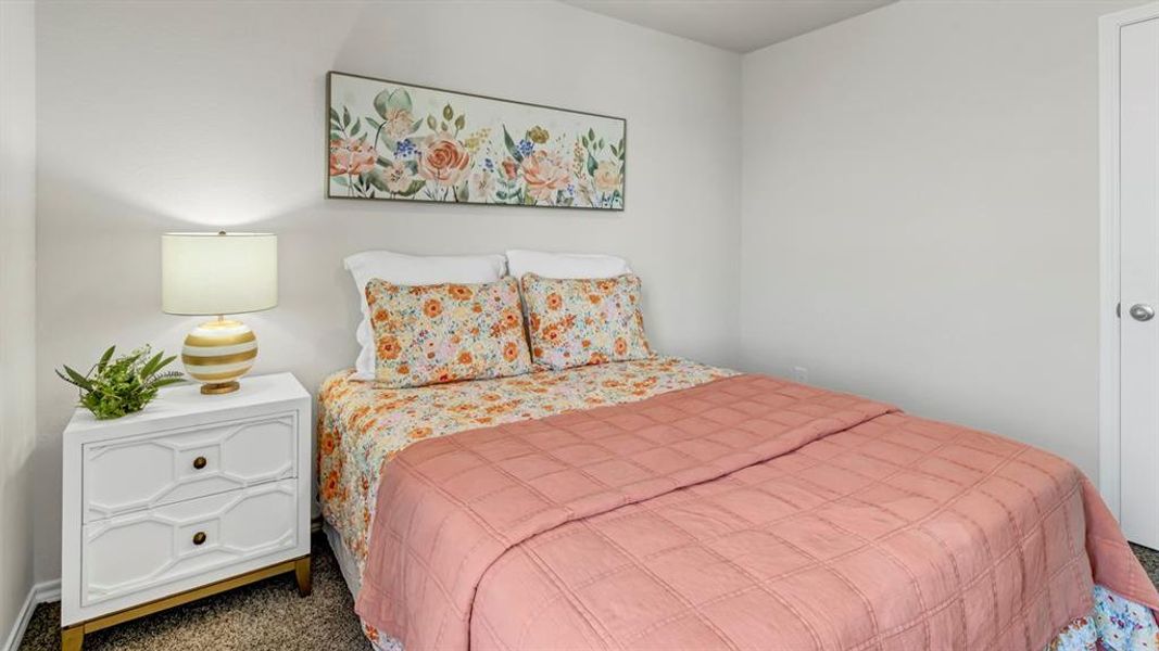 Bedroom featuring light-colored walls and soft carpet flooring Bedroom featuring light-colored walls and soft carpet flooring