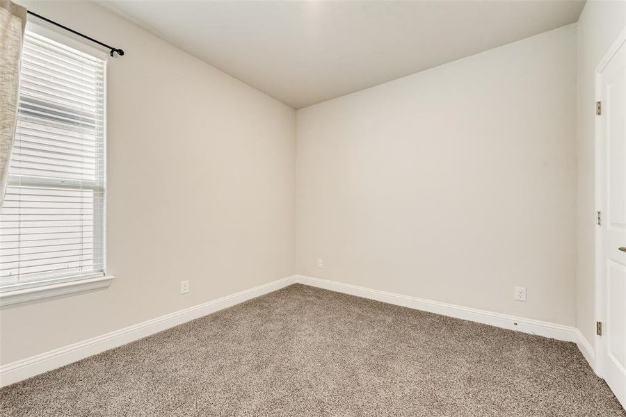 Empty room featuring carpet floors and baseboards