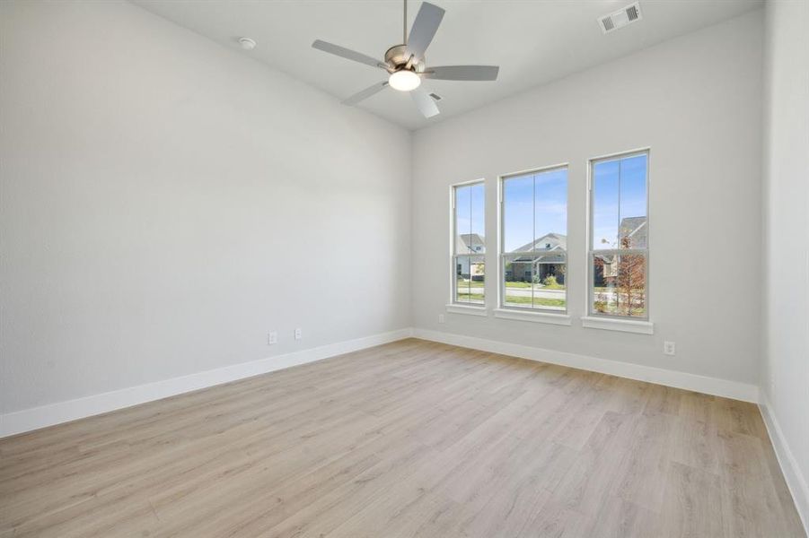 Spare room with ceiling fan and light hardwood / wood-style flooring