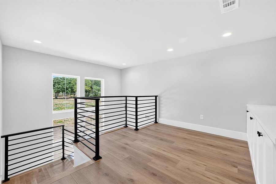 Upper level loft that features built in cabinetry. Upper level loft that features built in cabinetry.