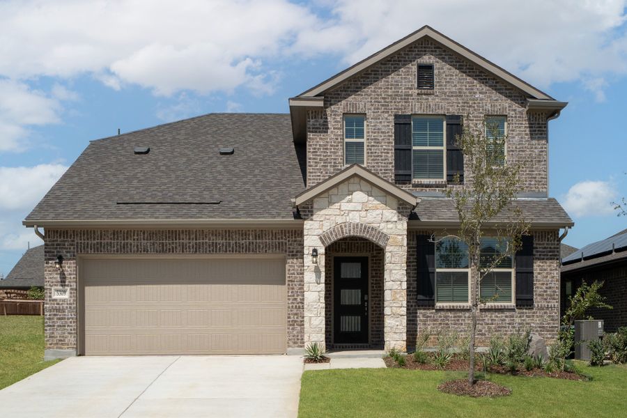 Front exterior of a new home in Stark Farms, Denton, TX, highlighting curb appeal (Image 1). Front exterior of a new home in Stark Farms, Denton, TX, highlighting curb appeal (Image 1).