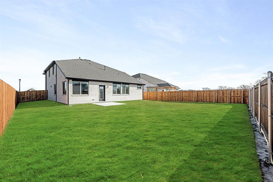 Exterior details and patio area of a home in East Oak Creek Elements, Commerce (Image 4).