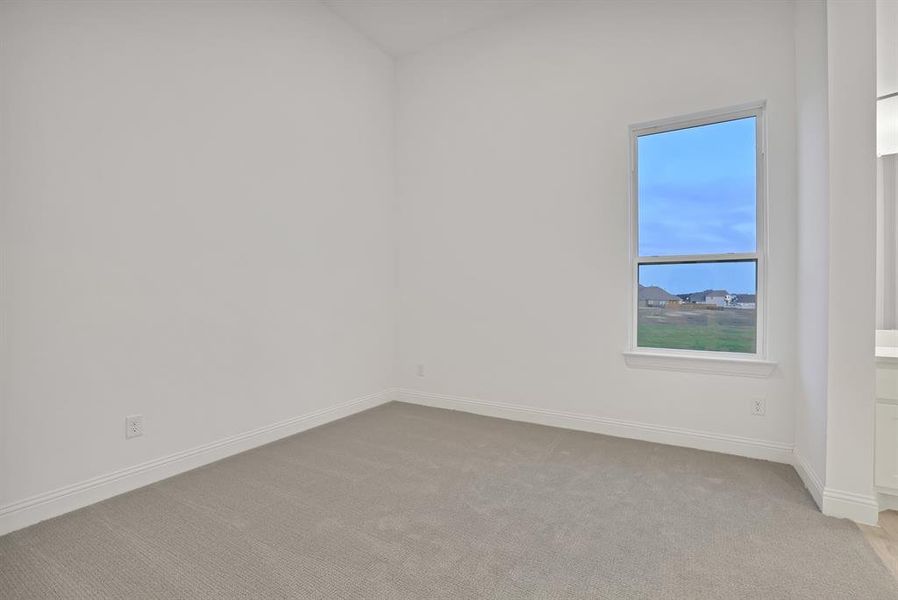 Bedroom with light carpet and vaulted ceiling