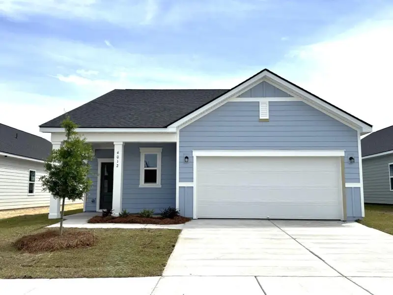 Front exterior of a new home in Tea Farm, Ravenel, SC, highlighting curb appeal (Image 2). Front exterior of a new home in Tea Farm, Ravenel, SC, highlighting curb appeal (Image 2).