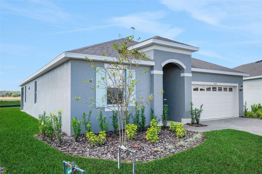 Front exterior of a new home in Reserve at Hammock Oaks, Lady Lake, FL, highlighting curb appeal (Image 2).