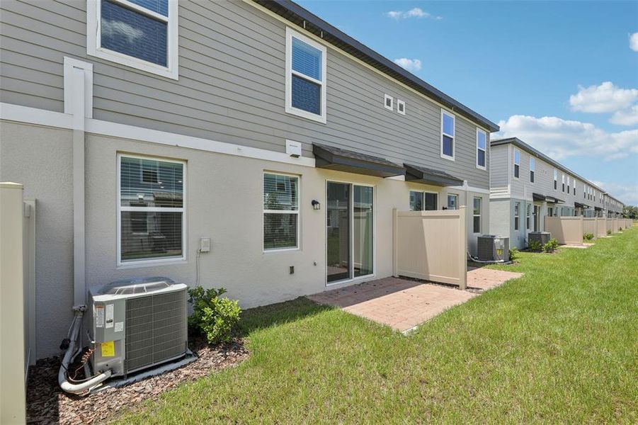 Exterior details and patio area of a home in The Meadow at Crossprairie Townes, St. Cloud (Image 24).