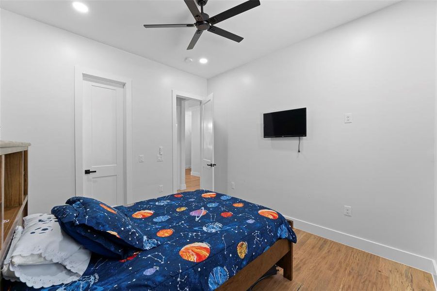 Bedroom with wood finished floors, ceiling fan, and recessed lighting Bedroom with wood finished floors, ceiling fan, and recessed lighting