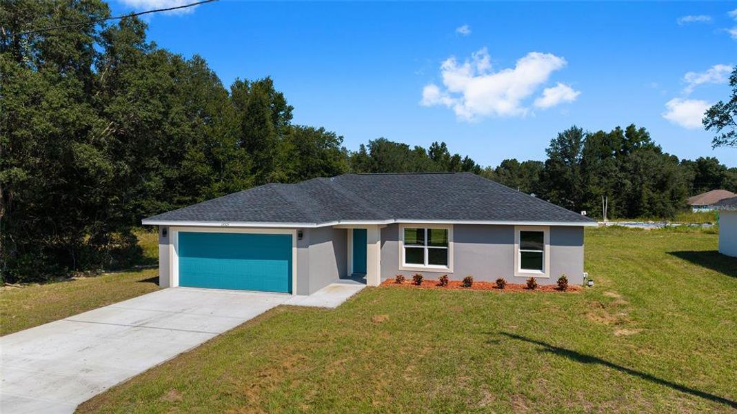 Front exterior of a new home in , Dunnellon, FL, highlighting curb appeal (Image 1).