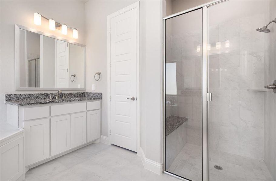 Full bath featuring a shower stall and vanity Full bath featuring a shower stall and vanity