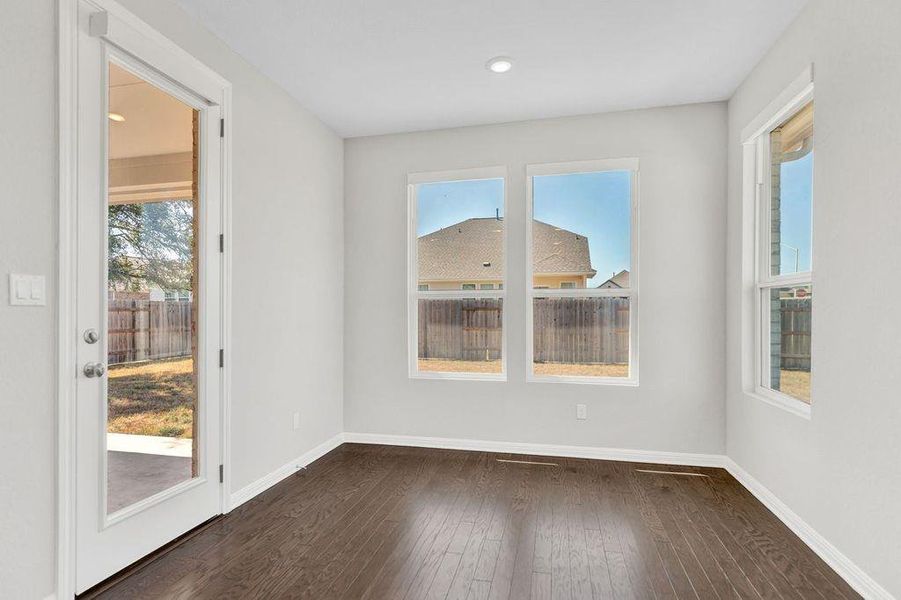 Unfurnished dining area with dark wood-style flooring and recessed lighting Unfurnished dining area with dark wood-style flooring and recessed lighting