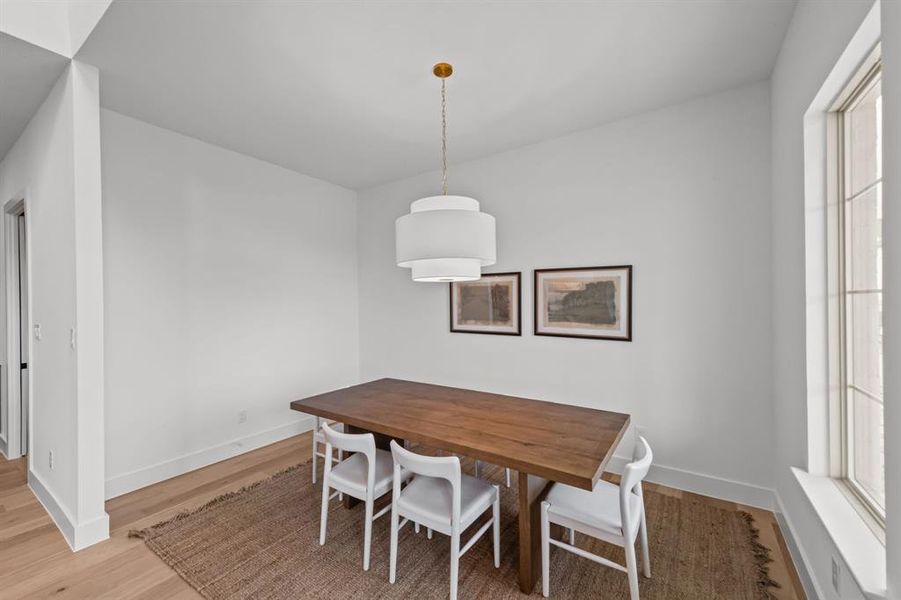 Dining area featuring hardwood / wood-style floors and a healthy amount of sunlight