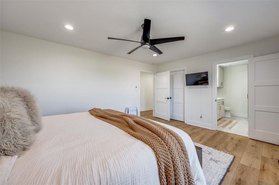 The primary bedroom features a large walk-in closet with custom built-ins and ensuite bathroom.