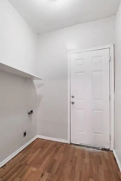 Washroom with wood finished floors and hookup for an electric dryer Washroom with wood finished floors and hookup for an electric dryer