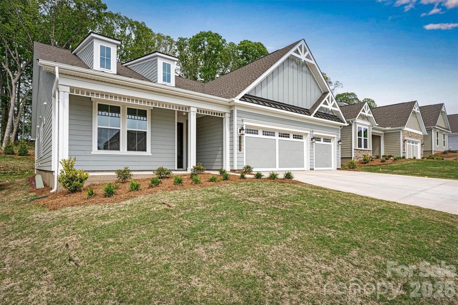 Front exterior of a new home in Cresswind Charlotte, Mint Hill, NC, highlighting curb appeal (Image 2). Front exterior of a new home in Cresswind Charlotte, Mint Hill, NC, highlighting curb appeal (Image 2).