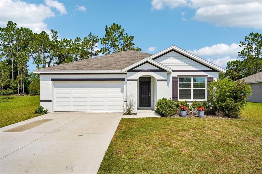 Front exterior of a new home in Lake Diamond, Ocala, FL, highlighting curb appeal (Image 22).