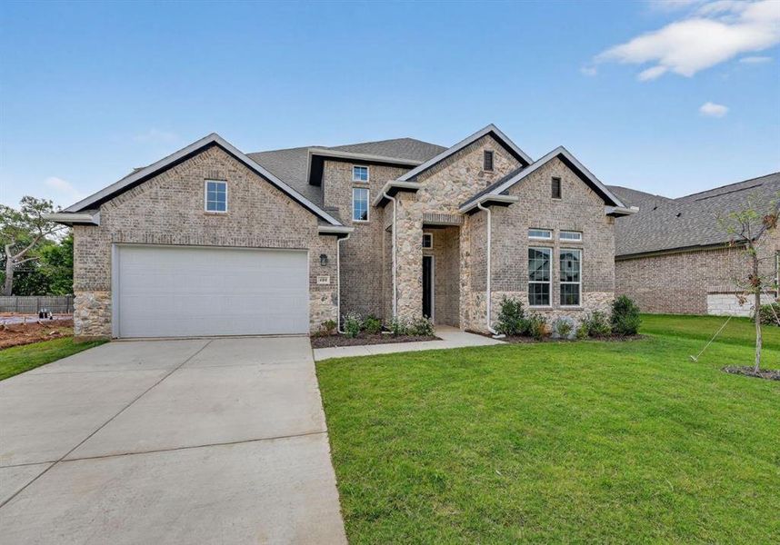 Front exterior of a new home in Legacy Estates, Mansfield, TX, highlighting curb appeal (Image 13). Front exterior of a new home in Legacy Estates, Mansfield, TX, highlighting curb appeal (Image 13).