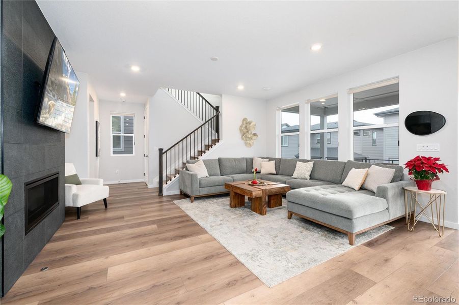 Living room located right off of the kitchen and dining area with custom, designer fireplace.