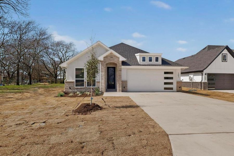 View of front of home featuring brick siding, concrete driveway, and an attached garage View of front of home featuring brick siding, concrete driveway, and an attached garage