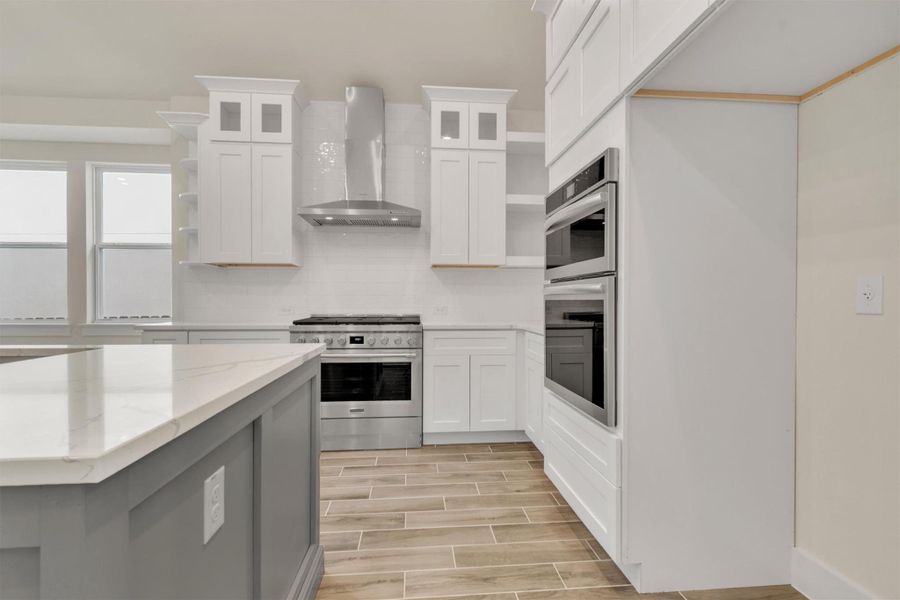 Bright, modern kitchen with sleek cabinetry and top-of-the-line appliances perfect for culinary pursuits.
