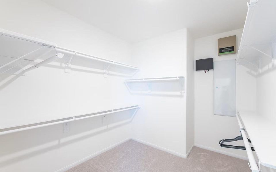 Spacious walk in primary closet offering excellent storage and organization, thoughtfully designed to keep everything neatly in place while complementing the comfort of the private primary suite. **Photos are representative only and may vary as built.**