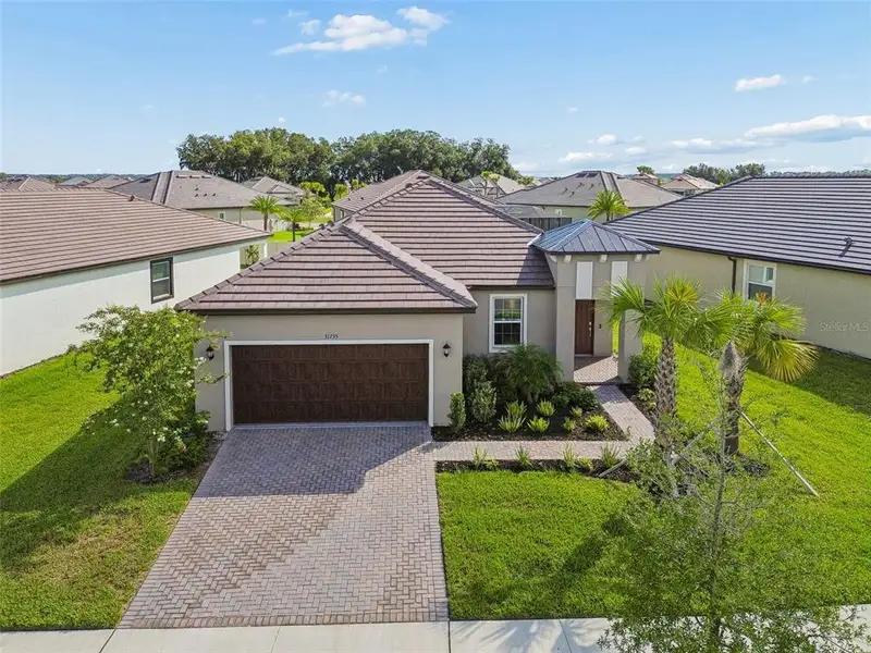 Front exterior of a new home in Mirada Active Adult, San Antonio, FL, highlighting curb appeal (Image 2).