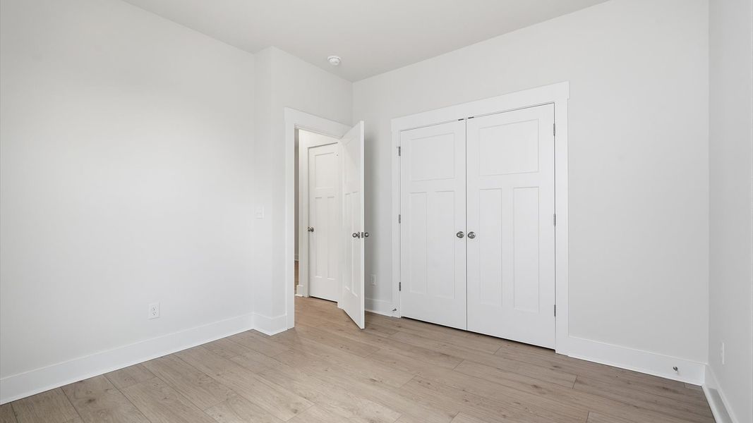 Notable secondary bedroom offering hardwood flooring and a stylish walk-in closet located in Moore, SC Notable secondary bedroom offering hardwood flooring and a stylish walk-in closet located in Moore, SC