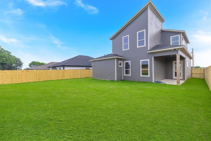Back of property featuring stucco siding and a patio area
