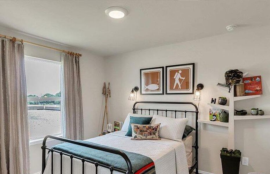 Bedroom featuring multiple windows and baseboards Bedroom featuring multiple windows and baseboards