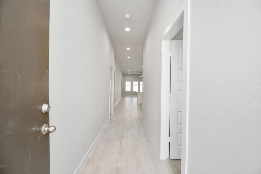 As you step into the threshold of this luxurious home, you'll soon be welcomed by an elegant glass door (to be installed). Inside, soaring ceilings amplify the spaciousness, while the refined wood-look tile flooring and oversized baseboards exude sophistication and charm. Sample photo of completed home with similar floor plan. Actual colors and selections may vary.