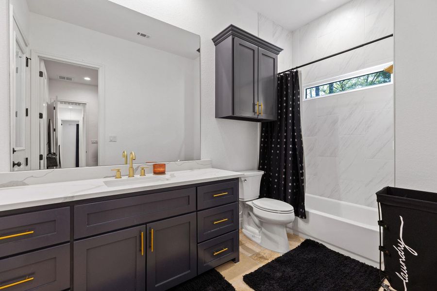 Bathroom featuring shower / bath combination with curtain and vanity Bathroom featuring shower / bath combination with curtain and vanity