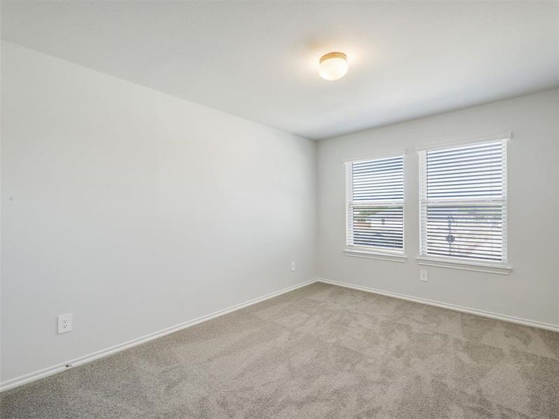 Spare room with baseboards and light carpet Spare room with baseboards and light carpet