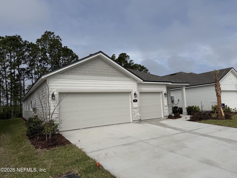 Front exterior of a new home in Reserve East, Flagler Beach, FL, highlighting curb appeal (Image 27).