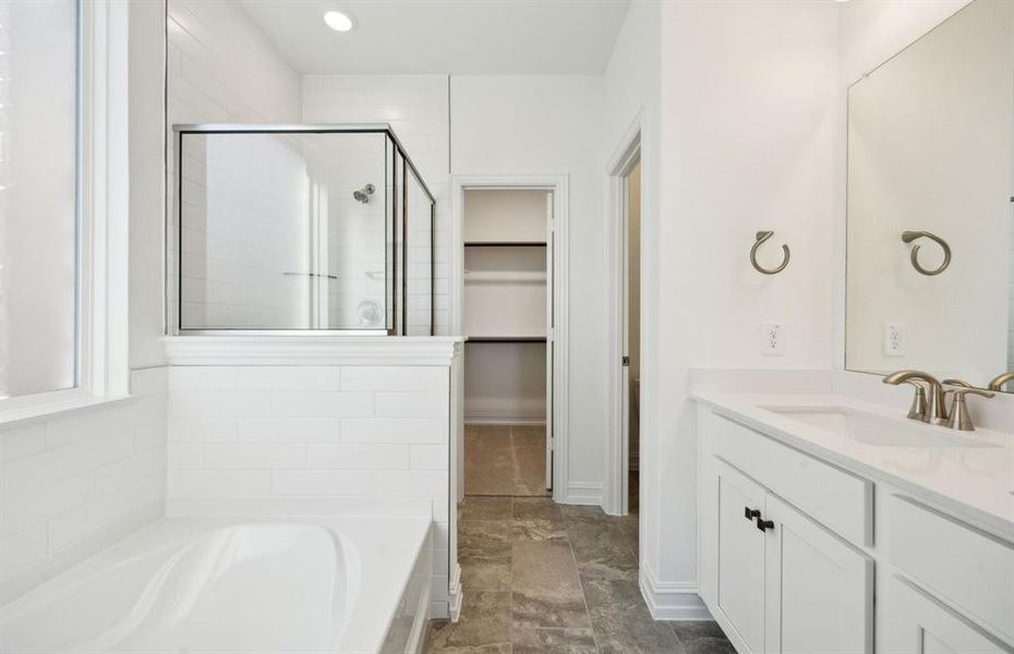 Elegant owner's bathroom with dual vanity *real home pictured