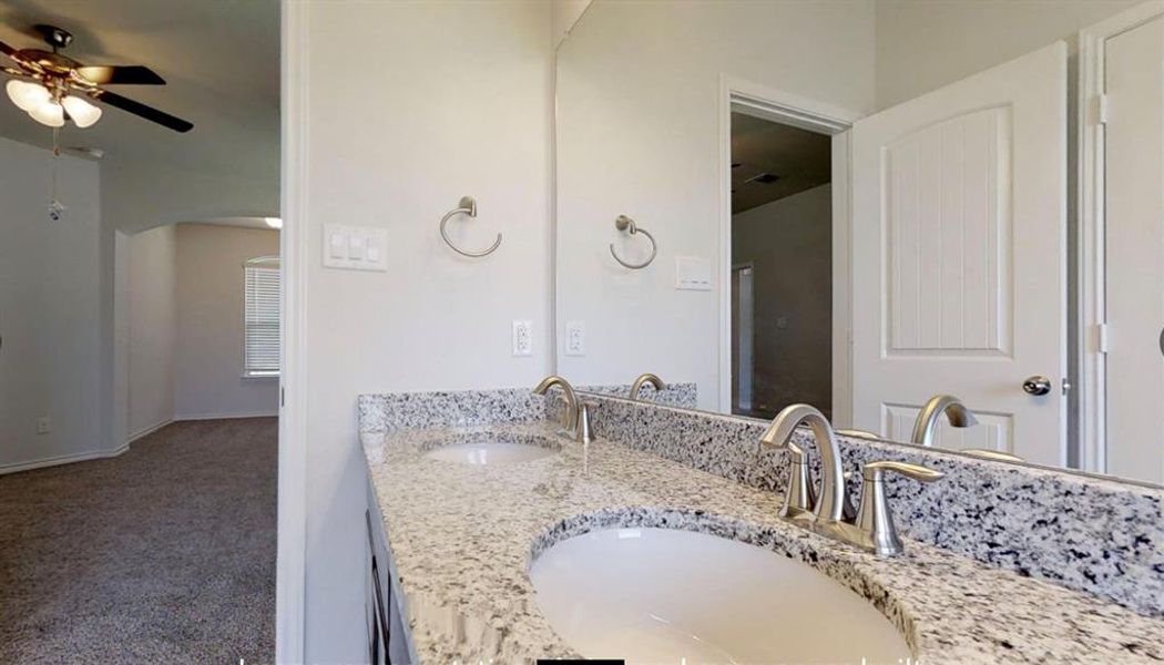 Bathroom with a ceiling fan and double vanity